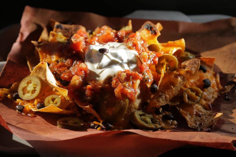 Loaded nachos on red parchment paper