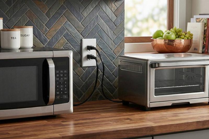 A toaster oven and microwave both plugged into the same outlet. 