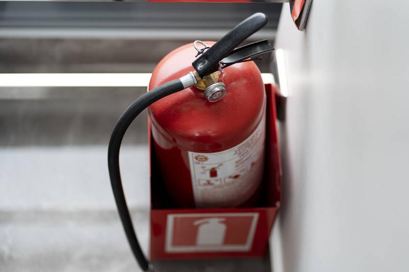A red fire extinguisher in a red box. 