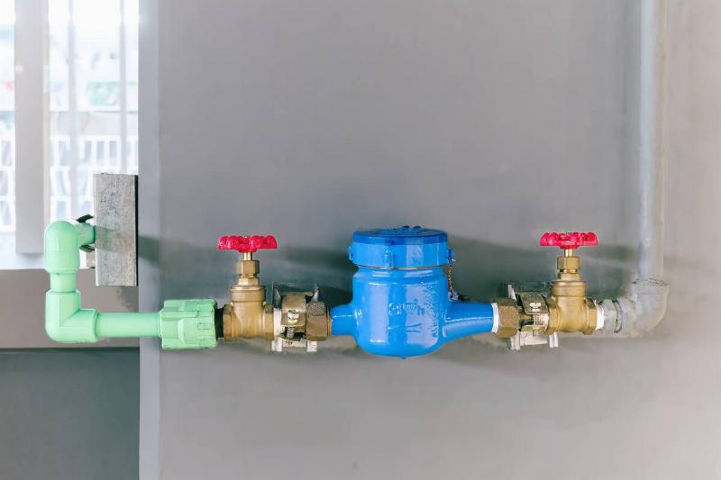 Two valves on an indoor water pipe. 