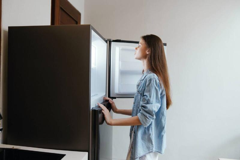 Woman looking into a freezer