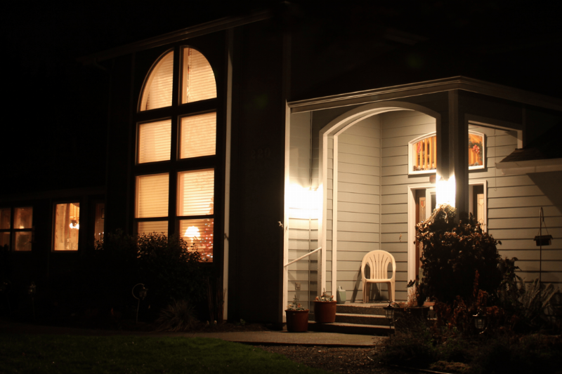 Lights on the outside of a house at night. 
