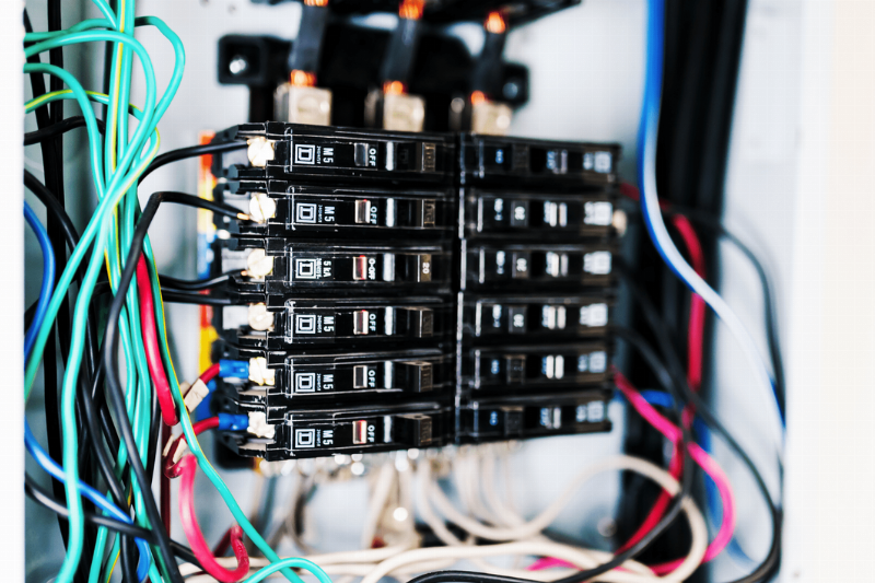 A circuit breaker connected to wires. 