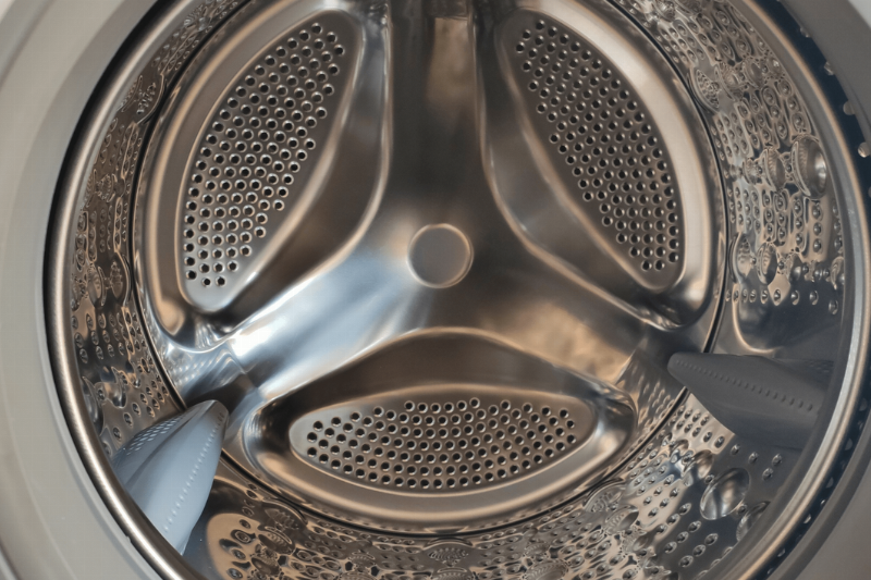 The inside of a front-loader washing machine.