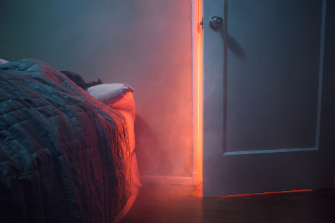 A smokey doorway in a dark room.