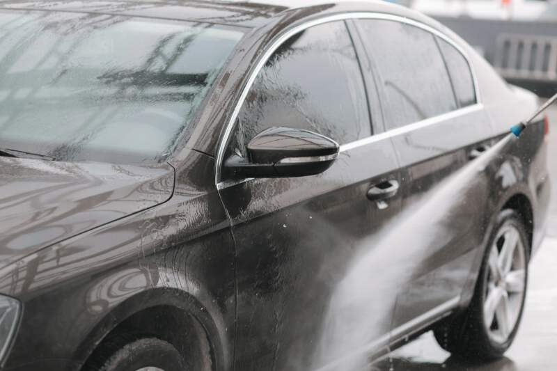 A car being pressure washed.