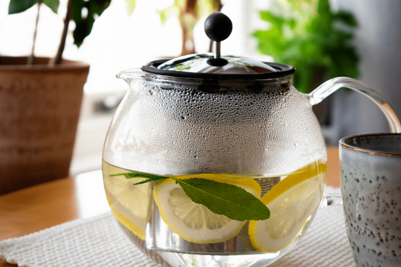 Citrus soaking in a tea pot. 
