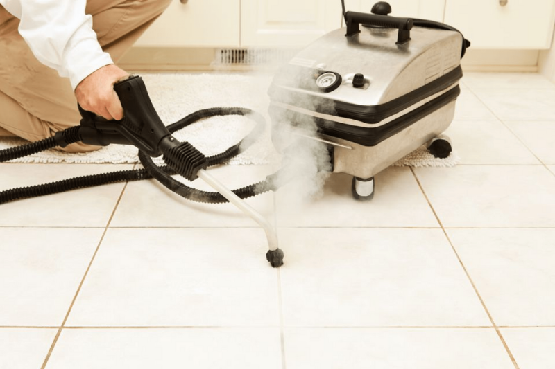 A person steam cleaning grout.