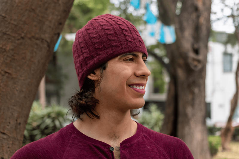 A man wearing a hat outside. 