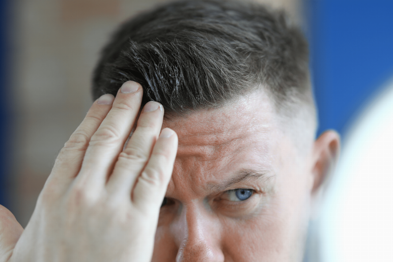 Man running hands through hair.