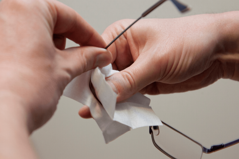 Wiping glasses with a wipe. 