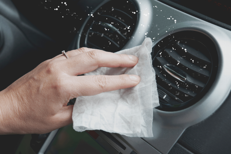 Disinfectant wipes used on a car interior.