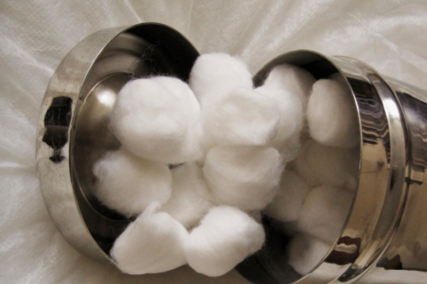 Cotton balls in a metal container. 