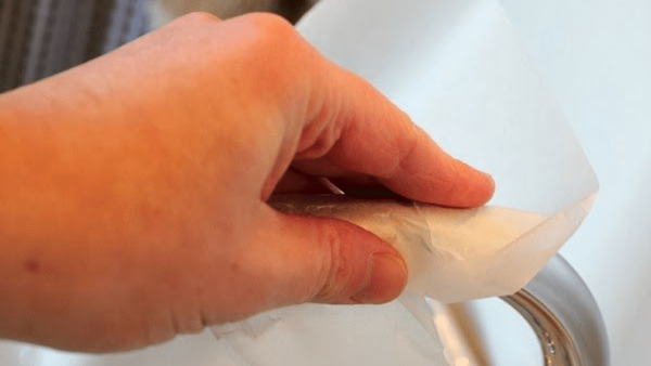Cleaning a faucet.