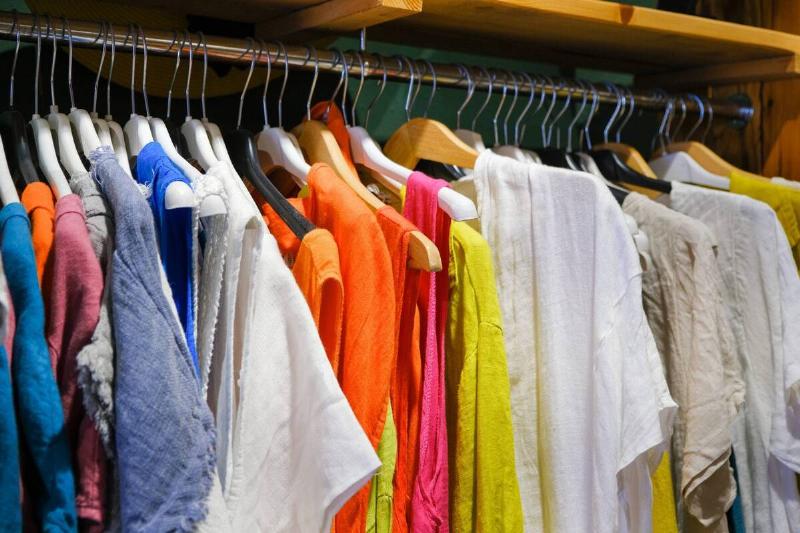 Racks of clothes hanging. 