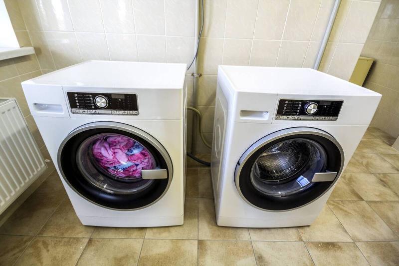 A washer and dryer on a tiled floor. 