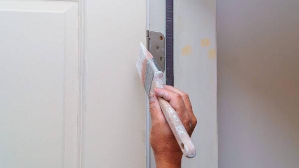 contractor-painting-a-wooden-door-white-in-a-new-h-2022-11-12-10-36-44-utc-47297-scaled-1-96222