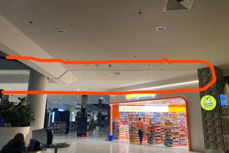 glass-barrier-hanging-from-roof-of-local-mall-v0-e4iffmklpr4g1