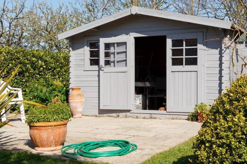 A shed in the back of a house. 
