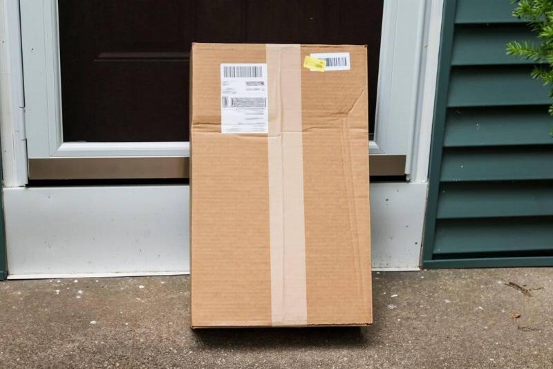 A package by the door of a house. 