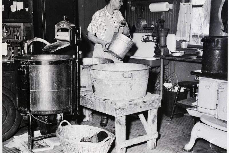 Housewife Is Shown Pumping Water In Kitc