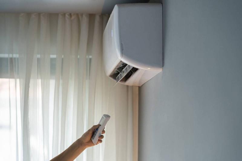Air conditioner being controlled with a remote.