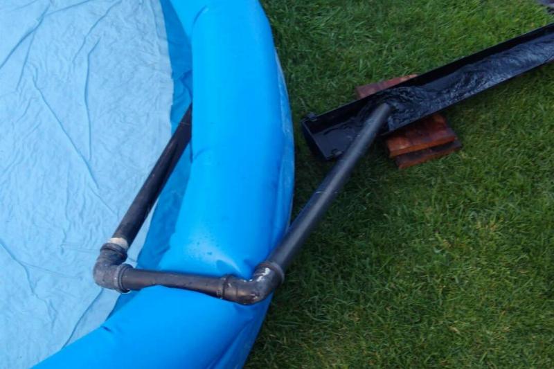 set-up-a-siphon-out-of-old-pipe-to-drain-the-kids-paddling-v0-bmu6000u0k151