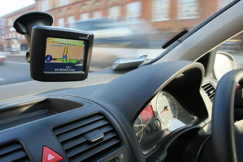 A Tomtom satellite navigation unit displays directions in a