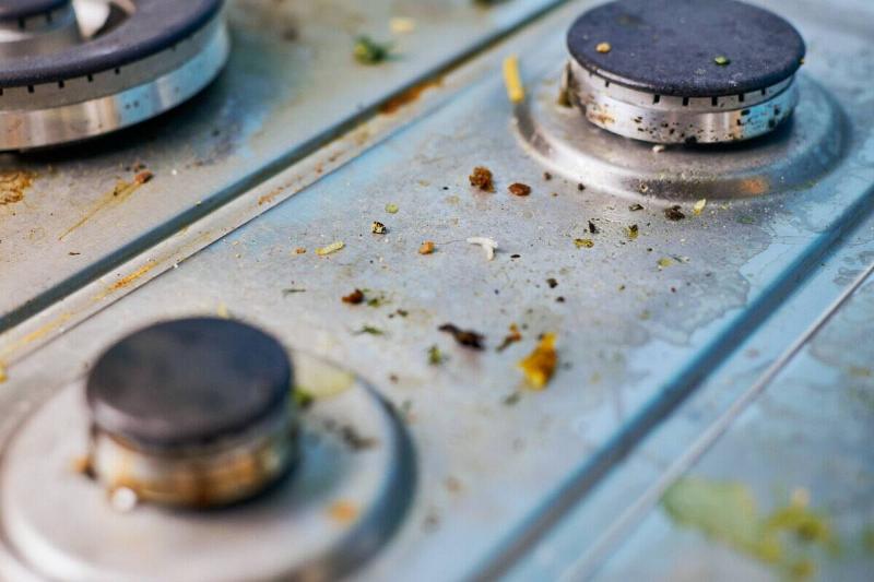 A dirty kitchen stovetop knobs. 