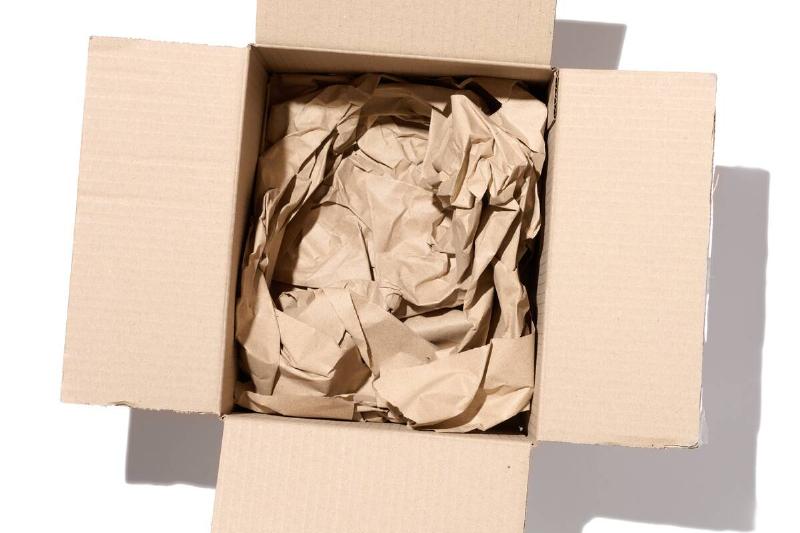 Open brown corrugated cardboard box with brown paper inside. 