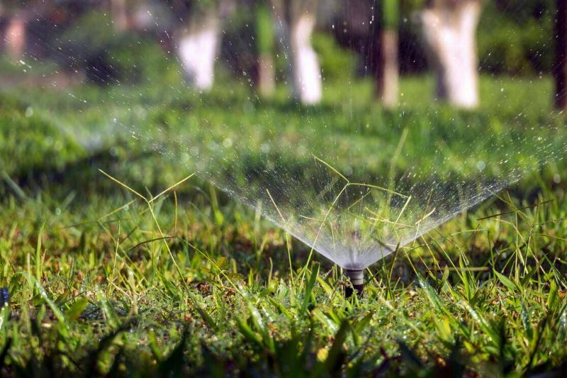 close up sprinkler system on lawn