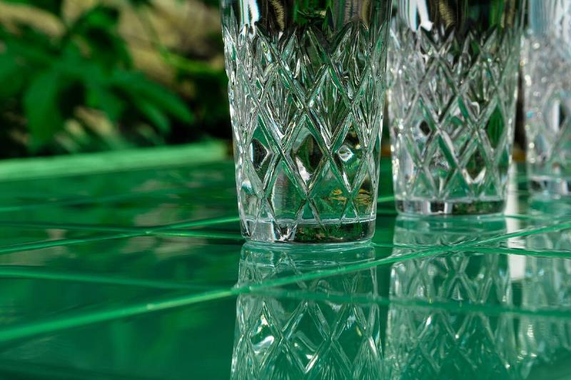 Crystal glasses on a green countertop. 