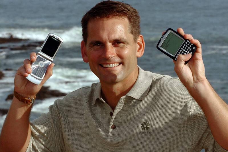 Traveler Uses Cellphone And BlackBerry