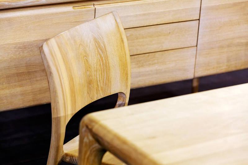 A wooden chair that is made of unsealed wood. 