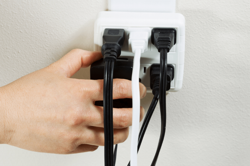 Many plugs plugged into an outlet.