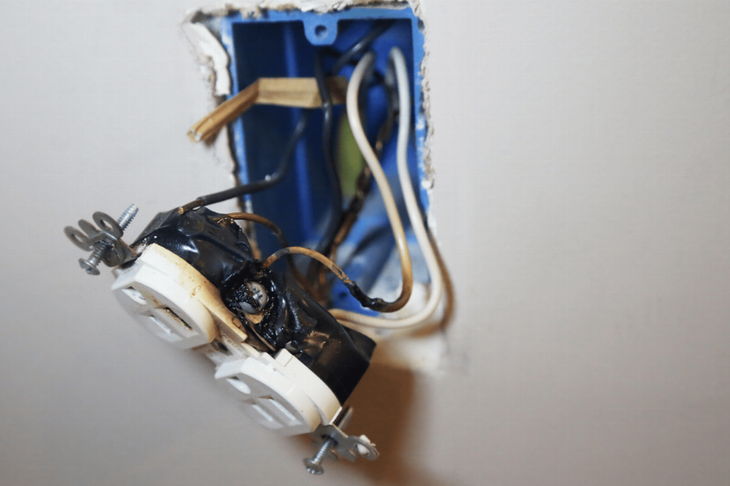 A plug that has fallen out of an outlet.