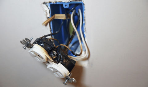 A plug that has fallen out of an outlet.
