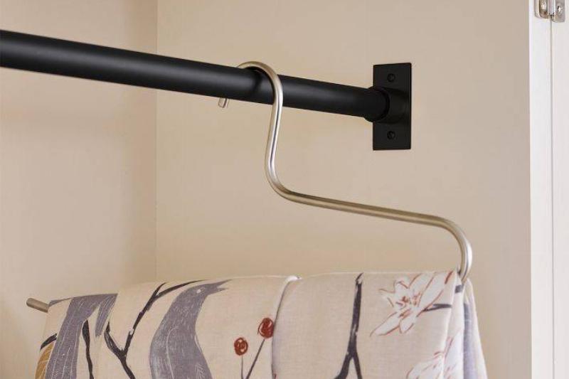 Hanger hanging on tension rod.