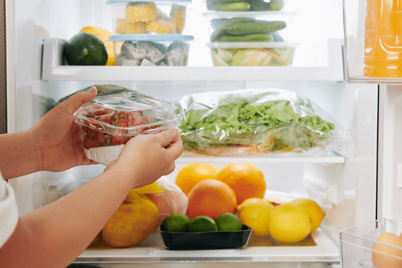 Putting vegetables in the fridge.