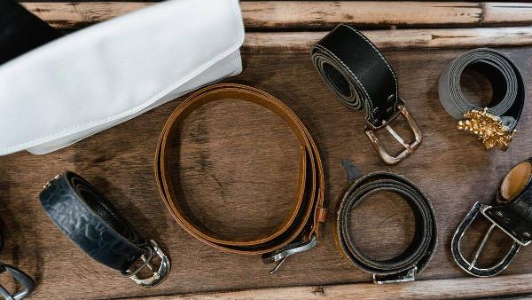 Rolled up belts on a tray.