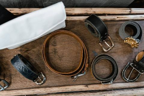Rolled up belts on a tray.