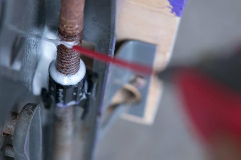 Spraying WD40 on the screws.