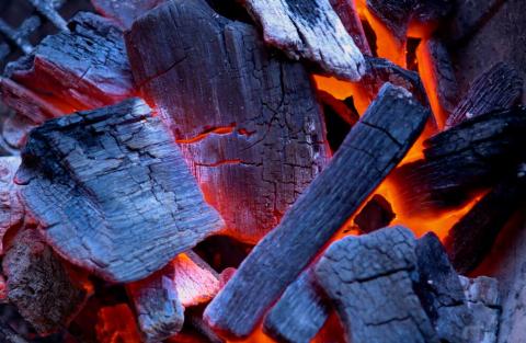 Wood burning in a grill.