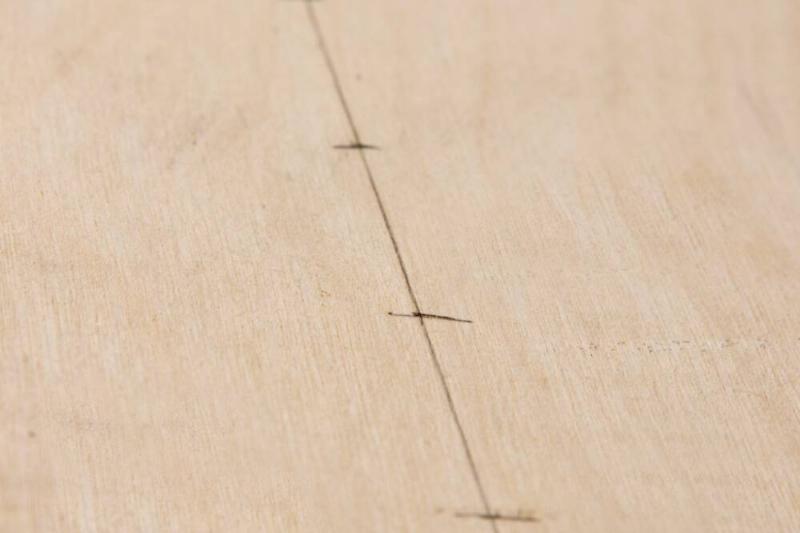 Spaced marks on a piece of wood. 