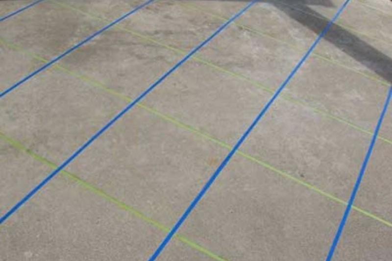 Tape on concrete patio.