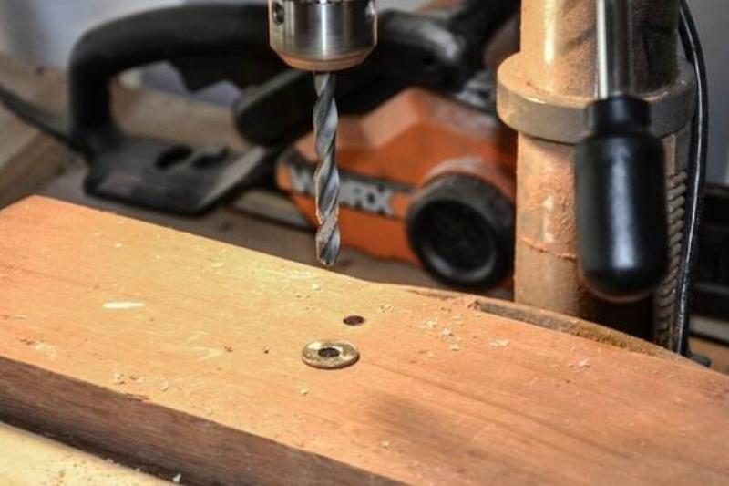 Drilling a hole in a coin.