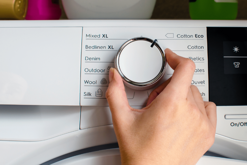 Picking a setting on a washing machine.