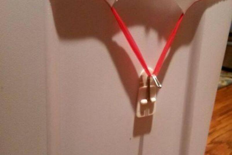 Command hook used to secure a garbage bag.