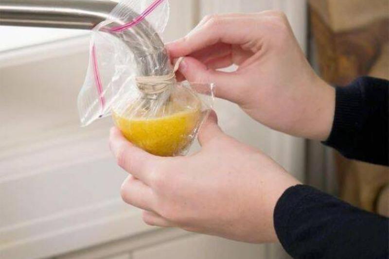 Lemon in bag over faucet.