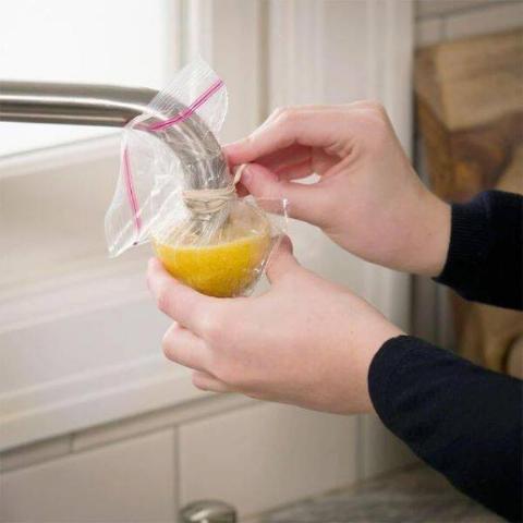 Lemon in bag over faucet.
